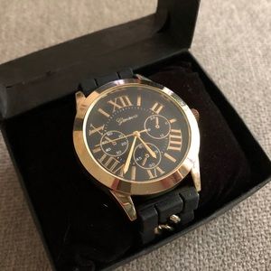 Black and Gold Wristwatch — Geneva
